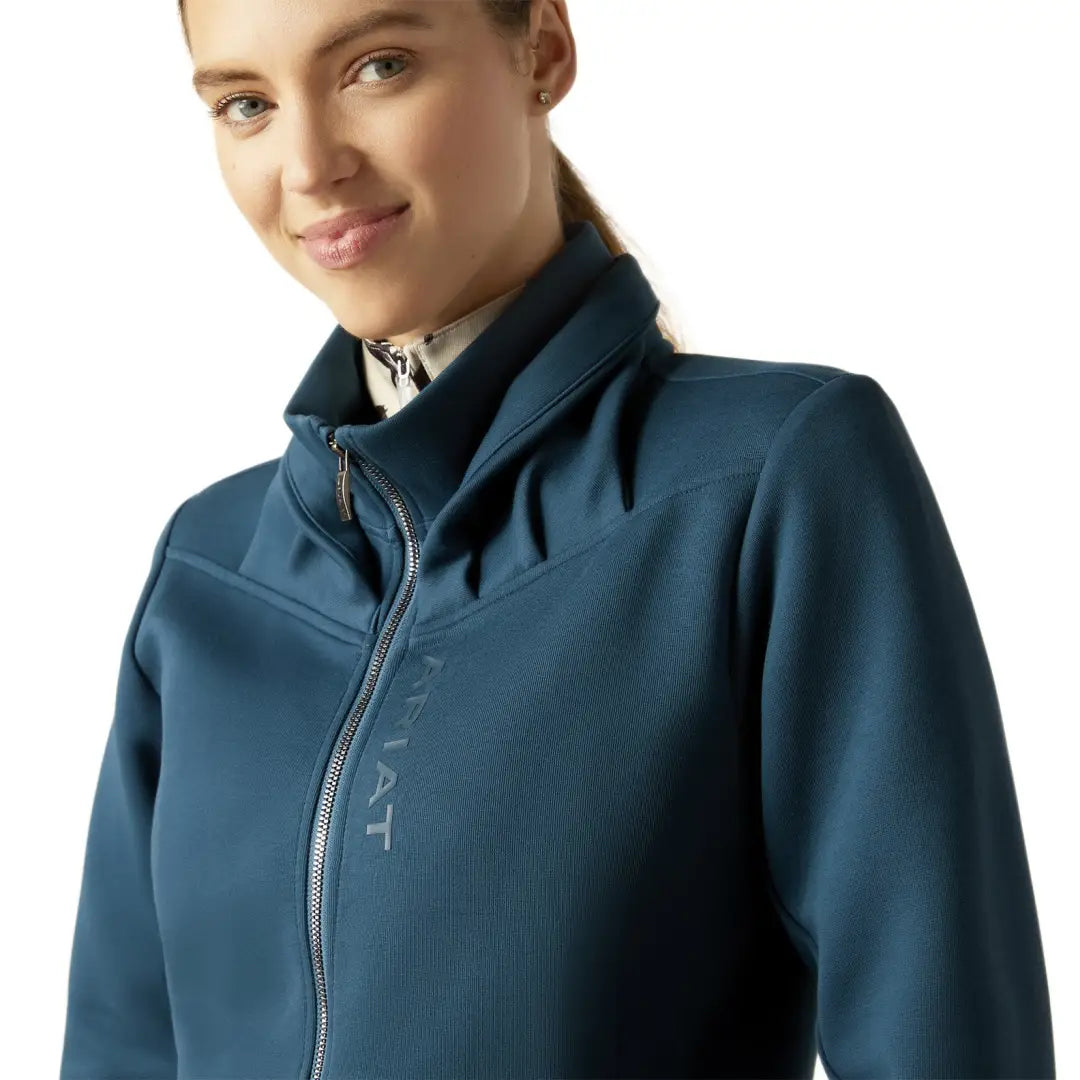 Woman in a teal blue Ariat Bess Full Zip Sweatshirt perfect for country clothing and outdoors