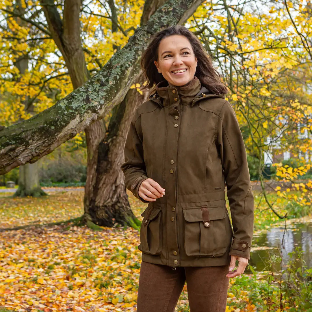 Woman in a brown Baleno Ladywood Jacket, perfect for outdoor adventures