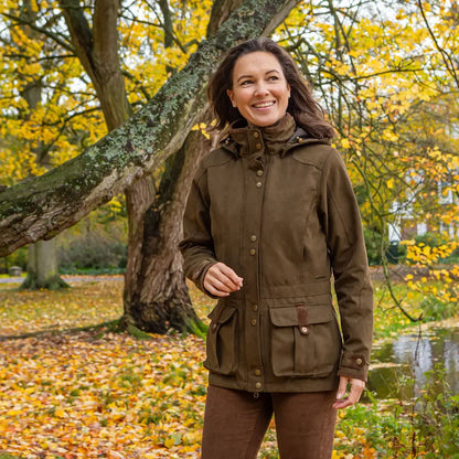 Woman in a brown Baleno Ladywood Jacket, perfect for outdoor adventures