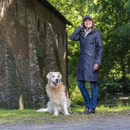 Woman in a blue coat with a golden retriever showcasing Baleno Twyford printed tweed