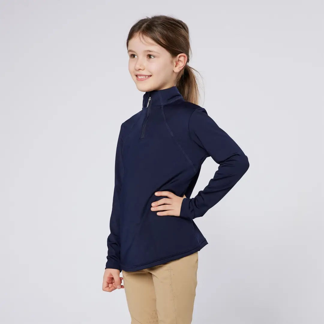 Girl wearing navy long-sleeve shirt and khaki pants in Cameo Junior Core Baselayer