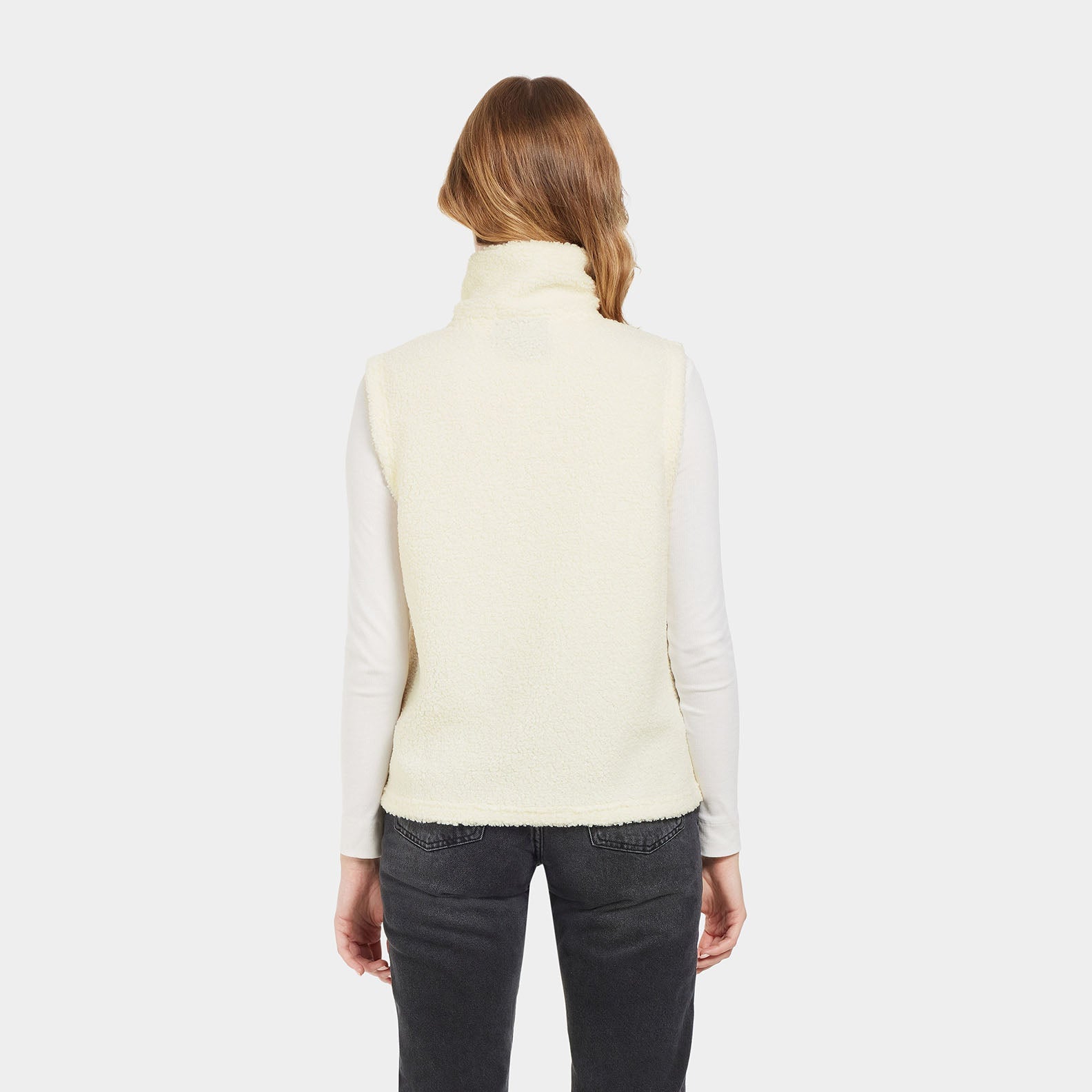 Woman wearing a cream Didriksons Kiana fleece vest perfect for country clothing outings
