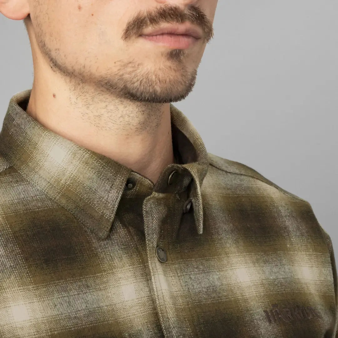 Plaid collar and facial features of a person wearing a Harkila Folke Shirt Jacket