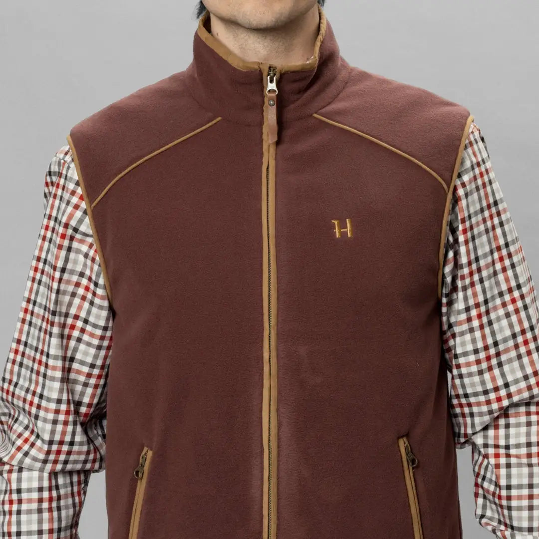 Burgundy Harkila Sandhem vest with gold accents over plaid shirt, perfect country clothing for hunting