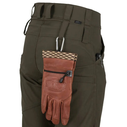 Dark green Helikon-Tex Woodsman Pants with a leather glove on the belt loop for outdoor enthusiasts