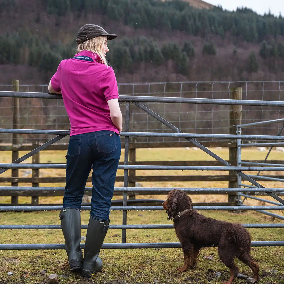 Woman in pink polo shirt with brown dog, showcasing Hoggs of Fife Cora Ladies Pique