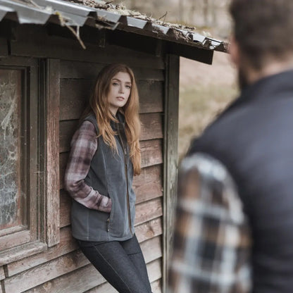 Young woman in plaid shirt and gray vest showcasing Hoggs of Fife Stenton Ladies Fleece Gilet