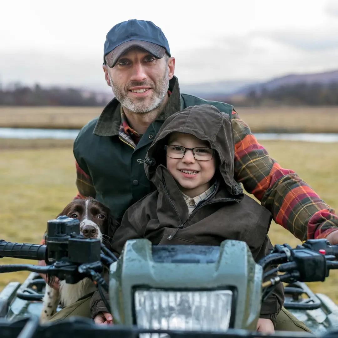 All-terrain vehicle with two riders in Fife Struther Junior Smock enjoying the outdoors