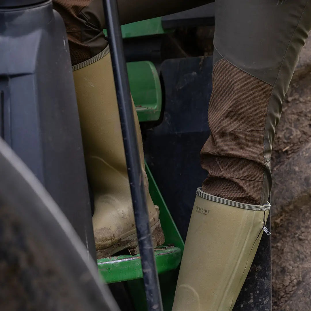 Tan rubber boots paired with brown pants in Jack Pyke Ladies Technical Trousers