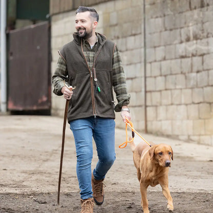 Man walking dog in Jack Pyke Melange Fleece Gilet Dark Olive outdoors