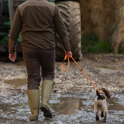 Man walking a dog in Jack Pyke Rannock Fleece Pullover, perfect for outdoor adventures