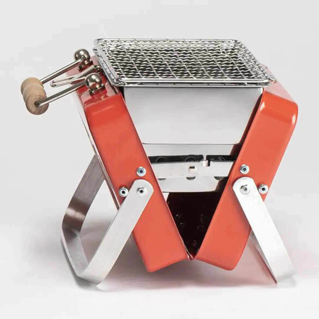 Portable orange Kenluck Mini Grill perfect for outdoor cooking and backyard BBQ fun