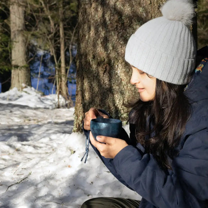 Woman holding a blue Kupilka Classic Cup, perfect for country clothing and outdoors adventures
