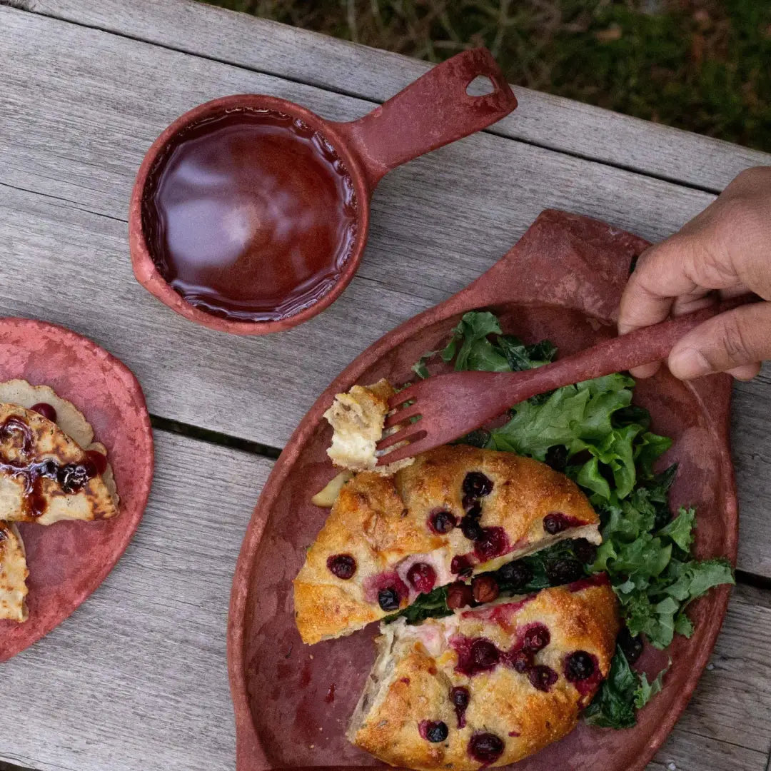 Rustic red clay tableware from Kupilka Classic Cup, perfect for outdoor adventures