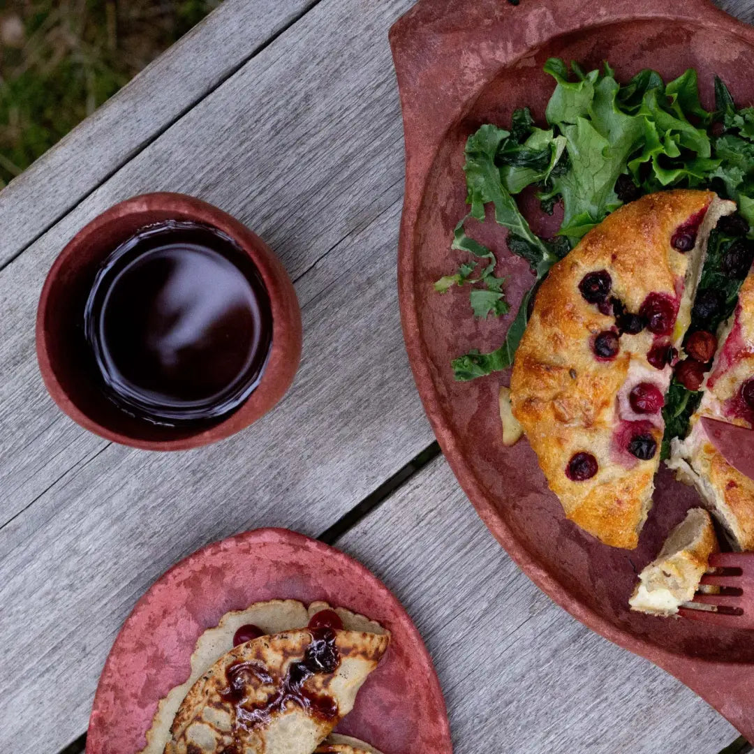 Rustic berry galette with greens in a Kupilka Cup for cozy country vibes
