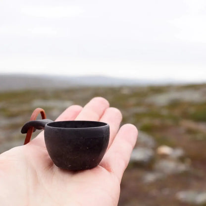 Small dark wooden Kupilka Mini Cup with handle, perfect for outdoor adventures