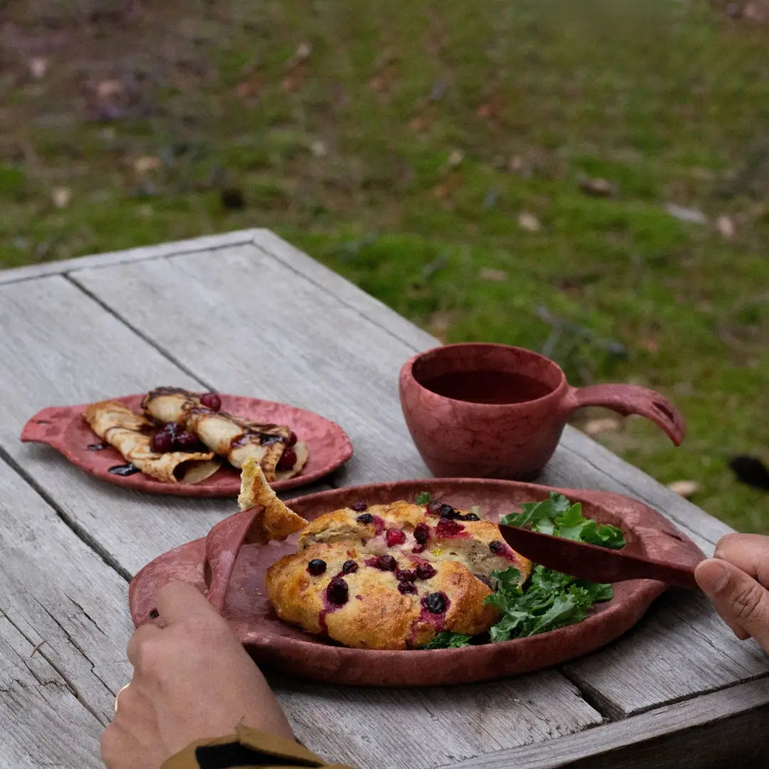 Rustic breakfast scene featuring a Kupilka Plate with country clothing and hunting vibes