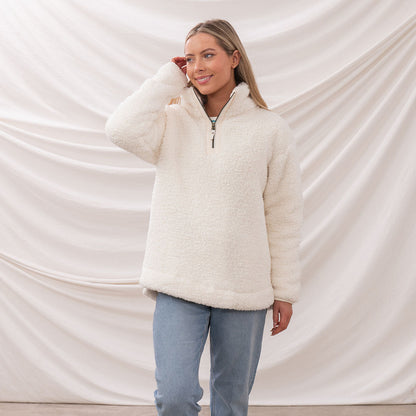 Woman in a cozy white fleece pullover from Lighthouse Ladies Bay collection