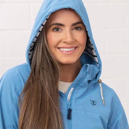 Light blue hooded raincoat from the Lighthouse Ladies Beachcomber II Coat collection