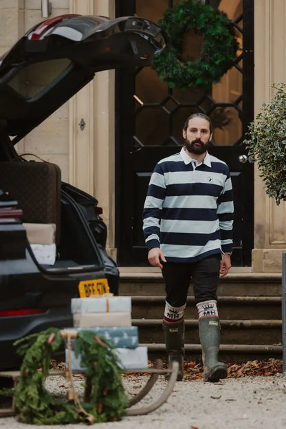 Man in striped shirt and boots showcasing New Forest Classic Stripe Rugby Shirt