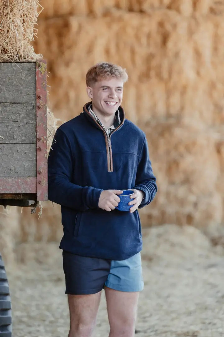Man in blue knightwood quarter zip fleece and two-tone shorts for casual style