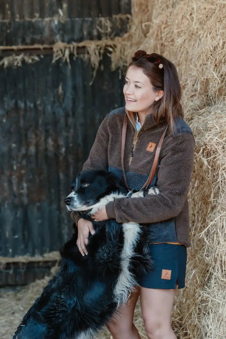 Woman hugging a black and white dog in New Forest Ladies Fox Fibre Pile Fleece