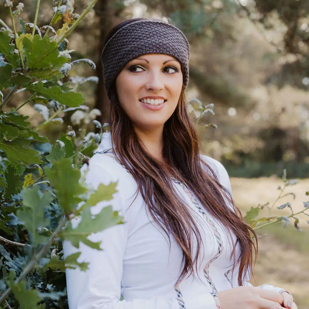 Woman modeling a stylish New Forest ladies knitted headband, perfect for cozy looks