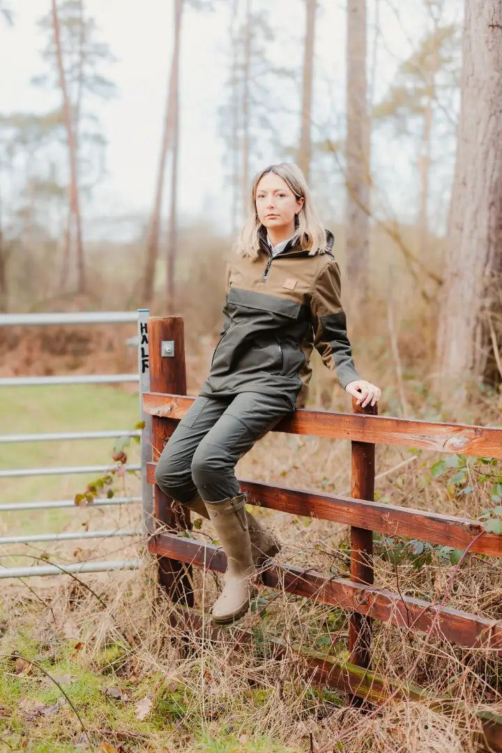 Woman wearing olive green and brown Forest Nightjar Trousers in the outdoors