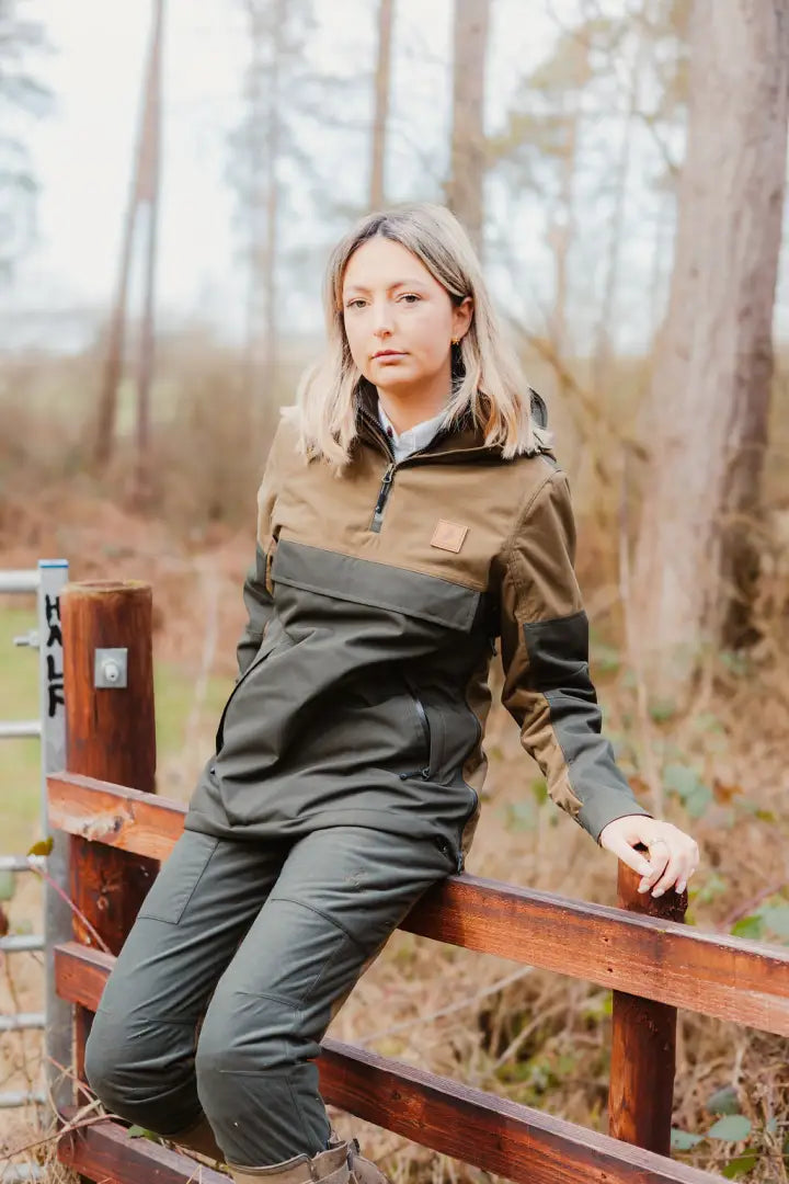 Woman wearing olive green and brown Forest Nightjar Trousers outdoors
