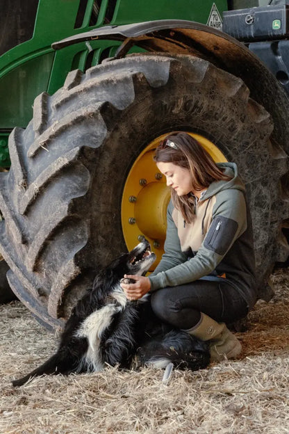 Woman petting dog near tractor tire in New Forest Ladies Raptor Hoodie forest raptor style