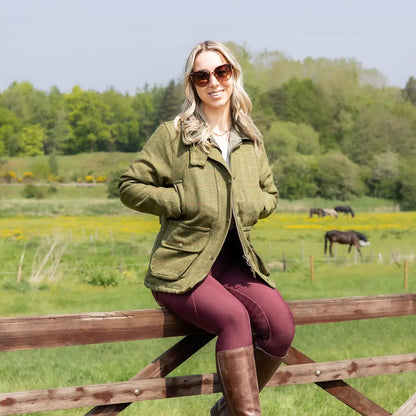 Woman in a wooden fence wearing a stylish Ladies Tweed Jacket in a rural setting