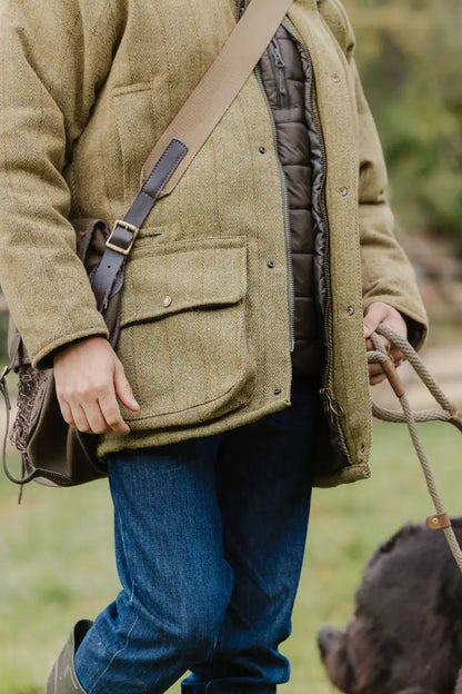 Model showcasing New Forest Tweed Shooting Jacket with stylish shoulder bag