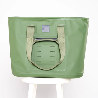 Pale green waterproof tote bag with beige handles and logo patch, featuring sleek welded seams