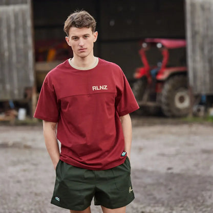 Young man in a burgundy RLNZ t-shirt and green shorts, perfect for country clothing outdoors