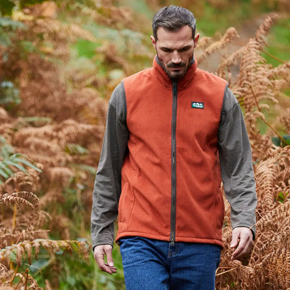 Man rocking the Ridgeline Kodiak Gilet in a stylish orange fleece vest
