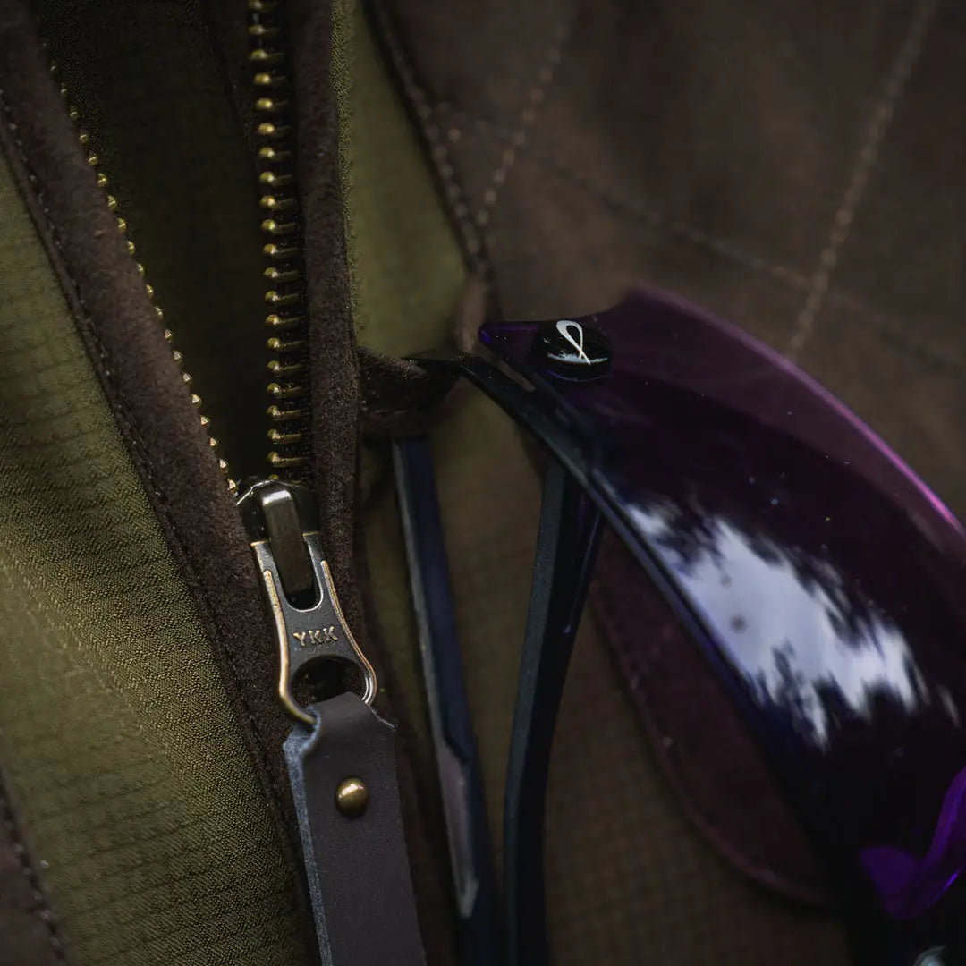 Olive green Seeland Wenlock Mens Jacket with brass zipper and stylish sunglasses