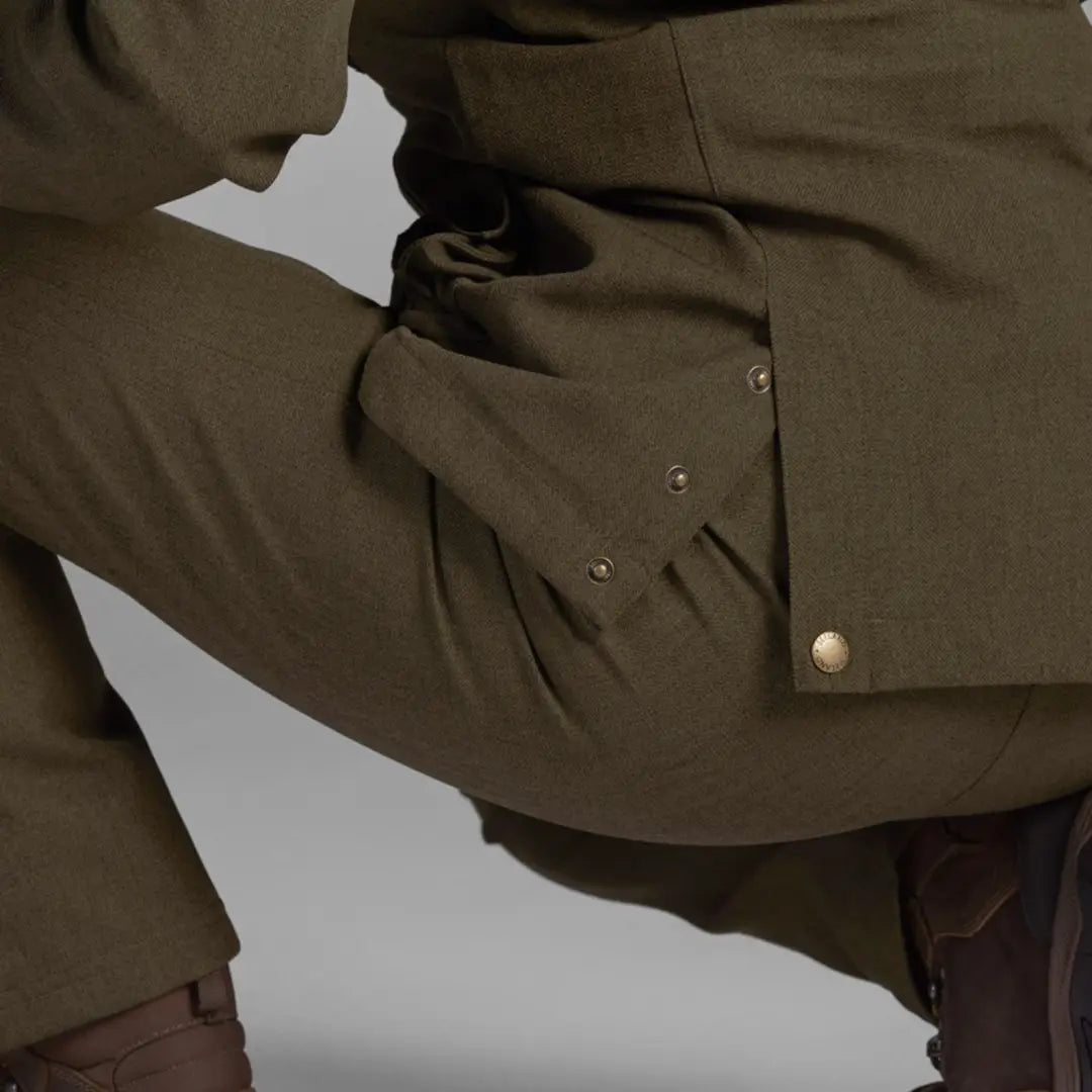 Olive green Woodcock Advanced Jacket with brass buttons and pockets for stylish practicality
