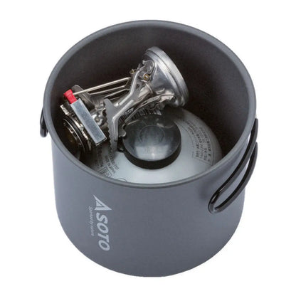 Camping stove and fuel canister inside Soto Amicus and New River Pot combo for outdoor cooking