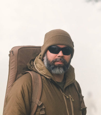 Man in winter gear rocking a Viper Tactical Bob Hat with a cool snake head logo